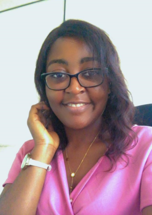 IkoRwanda team member smiling at her desk