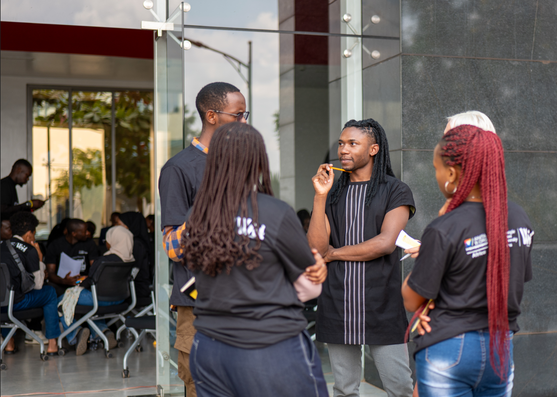 IkoRwanda team members networking outside a venue in Kigali