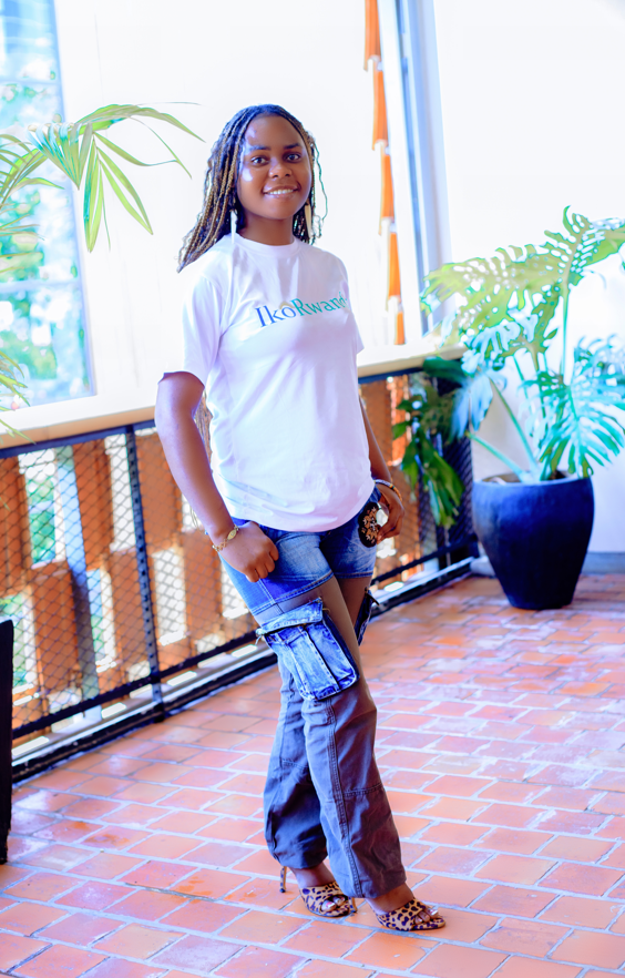 IkoRwanda team member smiling in branded white shirt